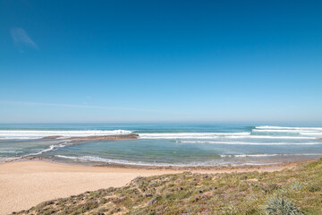 Huge beach Praia do Farol u města Vila Nova de Milfontes in the Odemira region, western Portugal. Wandering along the Fisherman Trail, Rota Vicentina