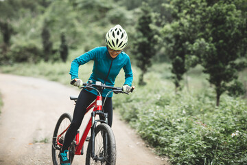 Fototapeta premium Riding bike in spring forest