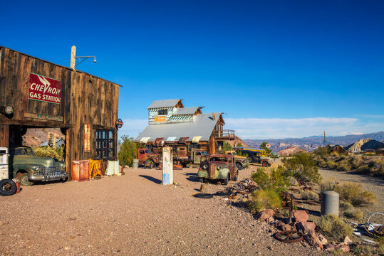 Nelson, Nevada, USA - October 23, 2018 : Old wooden houses, vintage fuel pumps and rusty car wrecks in Nelson ghost town located in the El Dorado Canyon and surrounded by Eldorado Mountains.