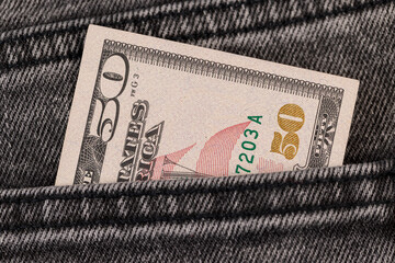 Obraz premium fifty dollars are in the pocket of gray jeans