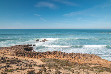 Mountainous and unstable rocky scenery at Atlantic Coast on a sunny day in the Odemira region, western Portugal. Wandering along the Fisherman Trail, Rota Vicentina