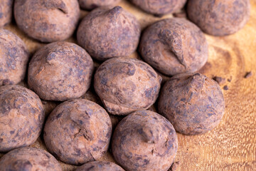 a large number of sweet candies in chocolate powder