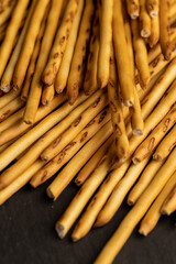 Thin and long bread sticks made of wheat flour on the table