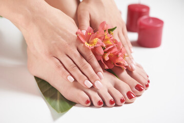 Manicure and pedicure on female hands and legs