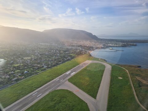 evocative image of the airport runway with the sea in the background
view from an airplane after take off