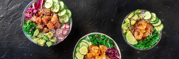 Poke bowl variety panorama. Healthy Hawaiian dish with salmon, tuna, and shrimps, overhead flat lay shot on a black background, a panoramic banner