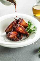 Baked chicken wings served with sauces, Restaurant menu, dieting, cookbook recipe top view