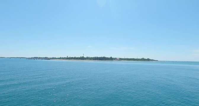 A small island in the middle of the blue sea