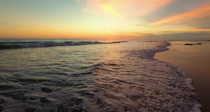 Sunset over the beach with sea waves 