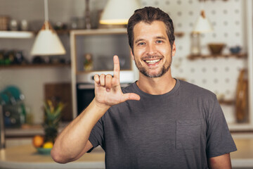 Young man showing gesture in sign language