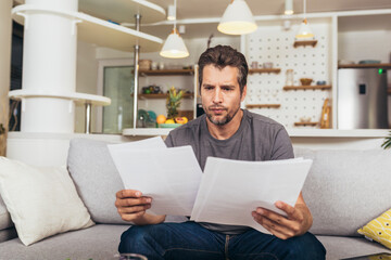 Young man working from home doing paperwork