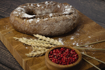 Bread on a wooden board and wheat. flour concept