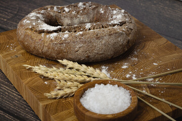 Bread on a wooden board and wheat. flour concept