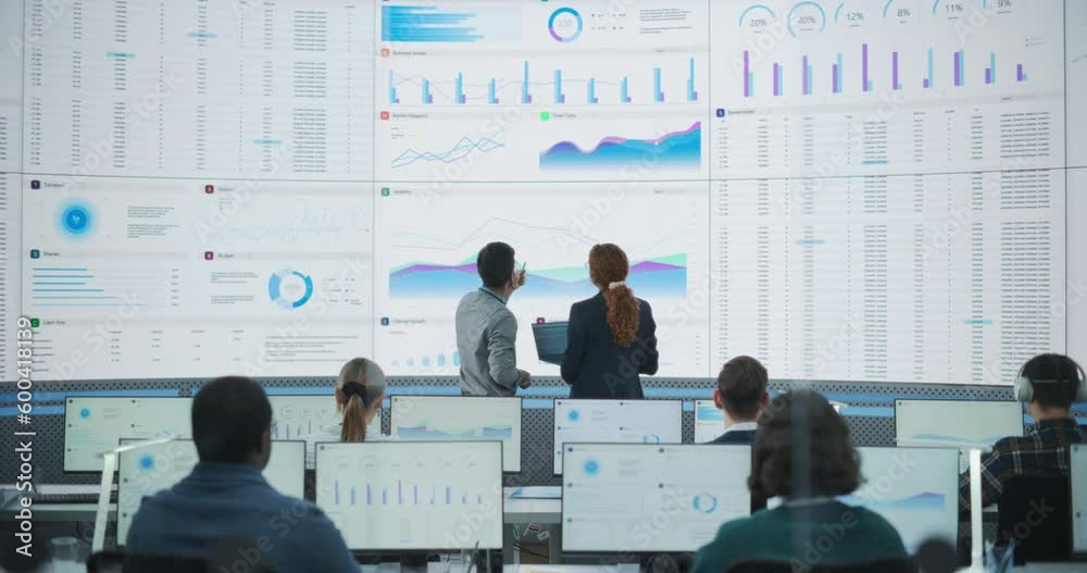Poster Wide Zoom In Back Shot Of Diverse Male And Female Risk Managers Analyzing Data On Digital Screen In Monitoring Room. Multiethnic Employees Working On Computers For Succesful Venture Capital Company