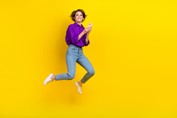 Fototapeta na wymiar Full body size photo of careless girl hold phone wear purple shirt formal style use phone for zoom call isolated on yellow color background