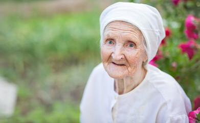 Portrait of senior woman looking up at camera and smiling