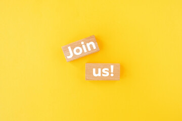 Join us sign on wooden cubes on yellow background
