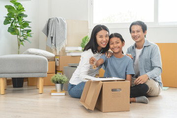 asian couple move into a new house showing a key home