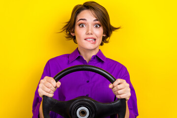 Photo of young nervous girl wear purple shirt hold steering wheel drive fast accidentally broke her car isolated on yellow color background