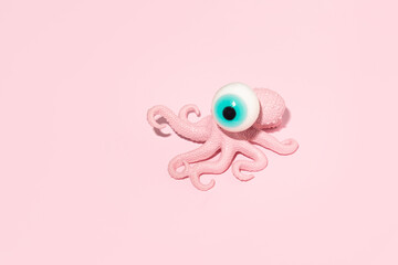 Punk octopus with one big blue eye on top, creative sea life layout, summer aesthetic trends.