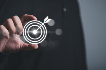 Man holding dart with  success goals Targeting the business concept. The concept of starting a new...