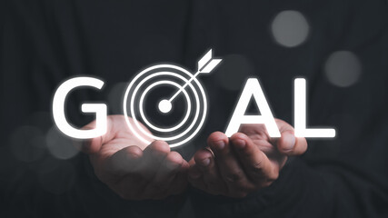 Man holding dart with  success goals Targeting the business concept. The concept of starting a new...
