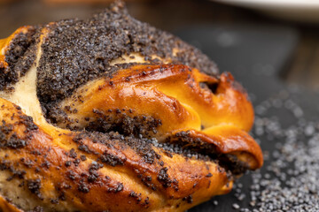 Fresh bun with poppy seed filling on the table