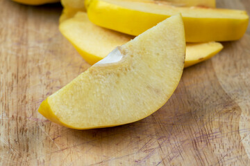 Sliced ripe yellow quince on a cutting board