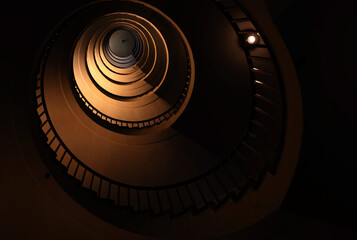 Spiral staircase in a tall multi-floor house, in the form of a 