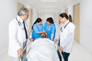 Team of indian nurse and doctor in a hurry taking patient to operation theatre for the surgery. Seriously Injured Patient, Emergency Department Health care Concept.