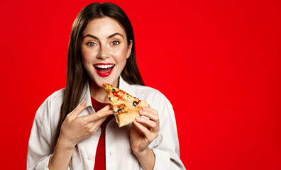 Portrait of smiling vegetarian woman holds vegan pizza slice, eats takeaway fastfood, order delivery in restaurant app, red background