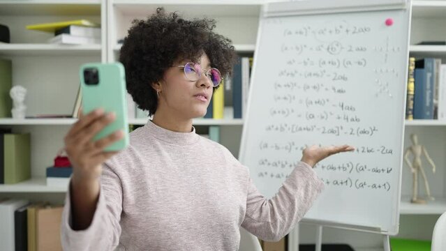 Young african american woman teacher teaching online maths lesson at university classroom