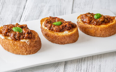 Ciabatta bruschettas with mozzarella and puttanesca