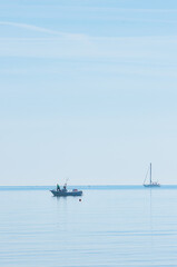 Two, adult, males, prepare boat for fishing, early morning, off Giulianova beach, Italy