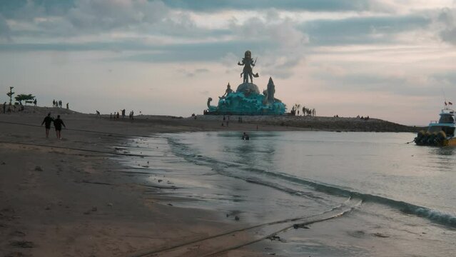 statue of Varuna (The God of Sky, Water and Ocean) in Pantai Jerman (German Beach) in Kuta, Bali Indonesia sunset shot	