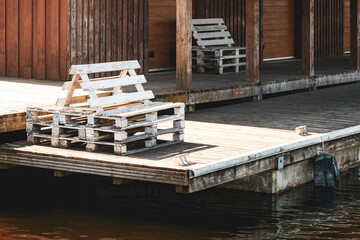 Wooden pier with a wooden chairs made from old pallets