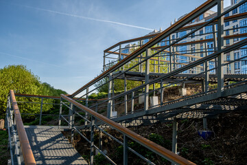 Metal stairs with railings in the park leading up.