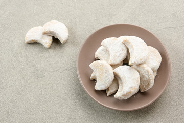 Kue Putri Salju or Snow White Cookies with crescent shaped. Made from flour, sugar and butter coated with powdered sugar. 
