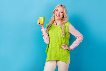 Photo of young business agent hr manager woman have rest drinking cappuccino hold cup wear stylish vest isolated on blue color background