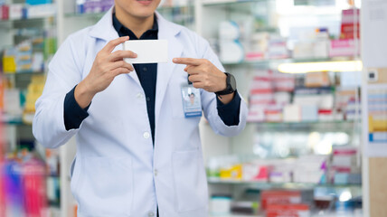 Pharmacy Drugstore. Portrait Professional Pharmacist handsome asian man showing the medicine box at...