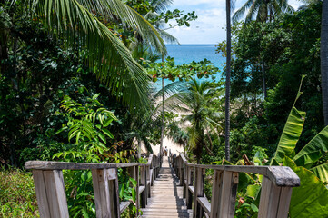 The wooden bridge goes down to the Naithon beach at Phuket, Thailand