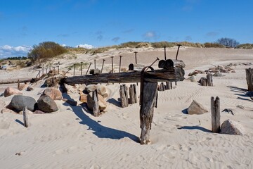 Fototapeta na wymiar Remains of a wooden sea pier. Sventoi, Lithuania. Selective focus.