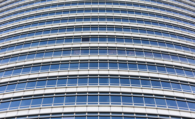 Blue sky reflecting in windows of modern office building