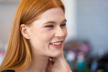 Fototapeta premium Portrait of beautiful redhead female smiling. Closeup woman face