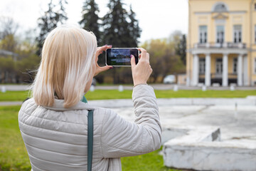 Moscow, Russia - April 20, 2023: woman photographing architecture