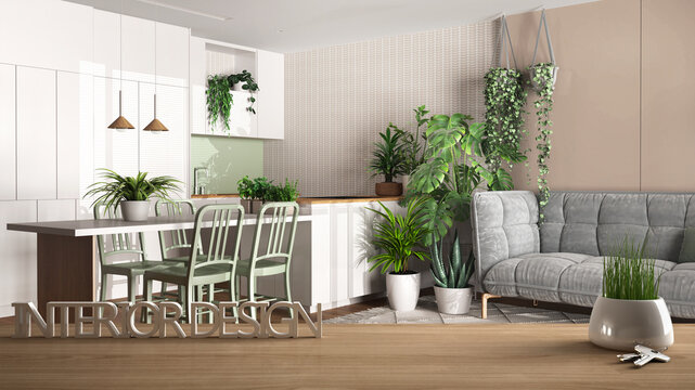 Wooden table, desk or shelf with potted grass plant, house keys and 3D letters making the words interior design, over modern living room and kitchen, urban jungle interior design