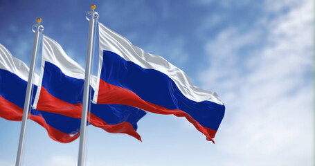 Three national flags of Russia waving in the wind on a clear day