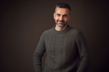 Obraz premium Portrait of a handsome middle-aged man in a gray sweater.
