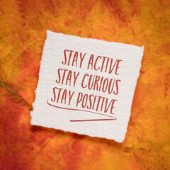stay active, curious and positive - the keys to healthy aging, inspirational note on an art paper