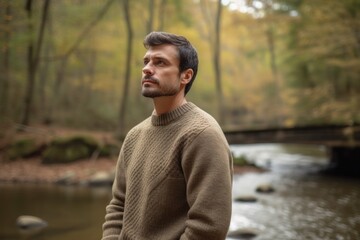 Portrait of a handsome man in the autumn forest. Outdoor shot.